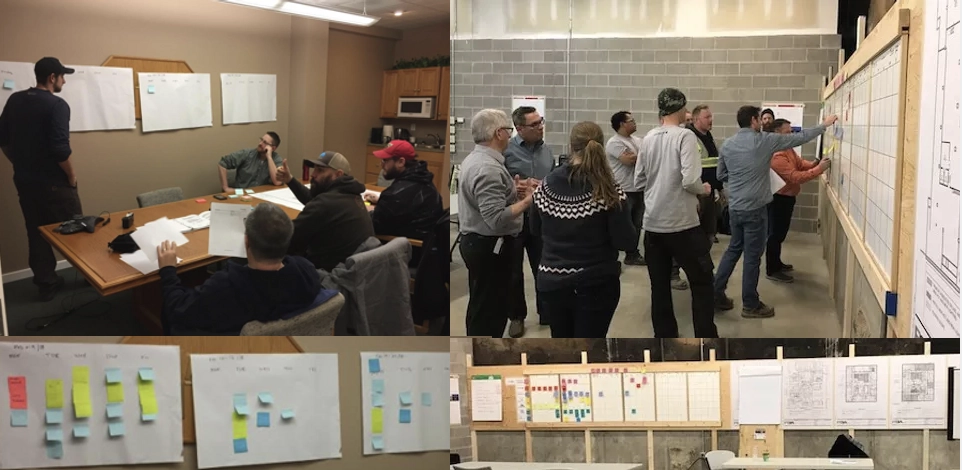People gathered around charts on the wall mapping out the progress of a project